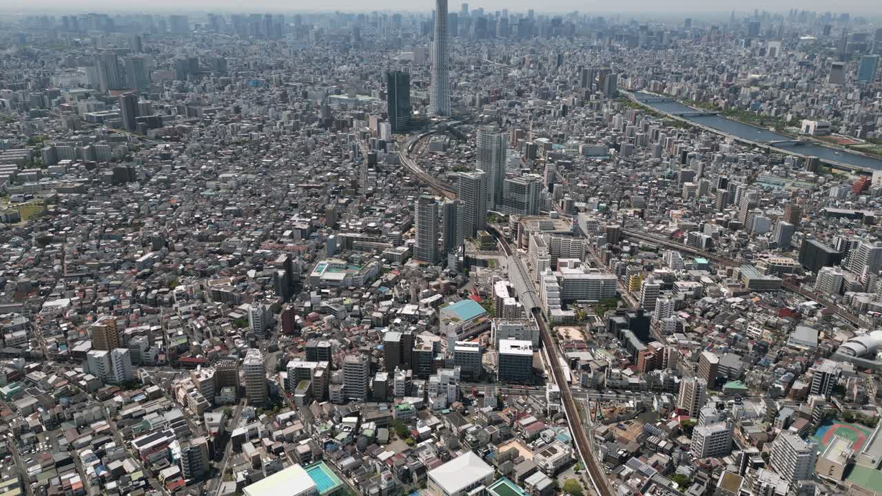 Aerial Scenic Urban Drone Footage of a neighborhood, streets and buildings in the Capital City of Tokyo, Japan on a Sunny Day
