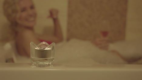 happy woman in bubble bath, relaxation treatment in wellness spa center, selective focus, slow motion