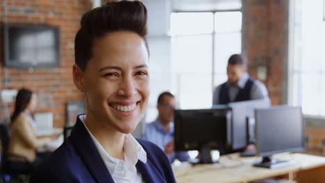 Female-Executive-looking-at-camera-in-office-4k