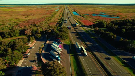 stunning aerial view of highway full of semi trucks due to trucking business industry