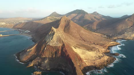 drone shot of red and brown mountains in porto santo, madeira