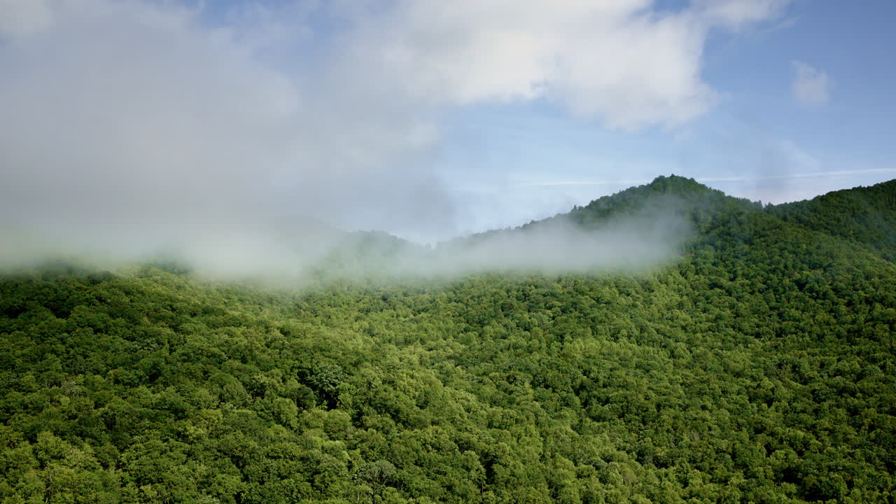 Drone flyover revealing the mist-covered Smoky Mountains in the USA
