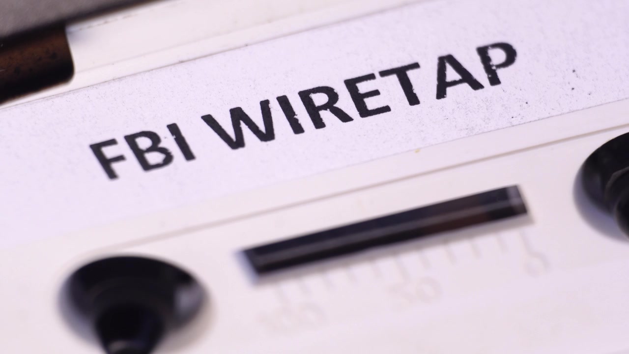 FBI Wiretap Recording on Audio Cassette Tape, Playing in Player, Macro Close Up