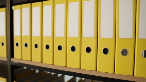 yellow binders on shelves