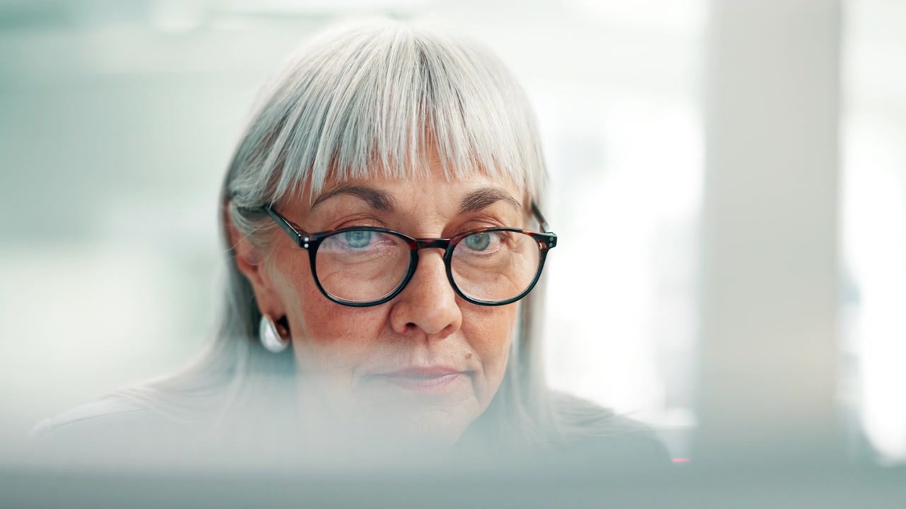 Mature Businesswoman Working on Computer in Modern Office