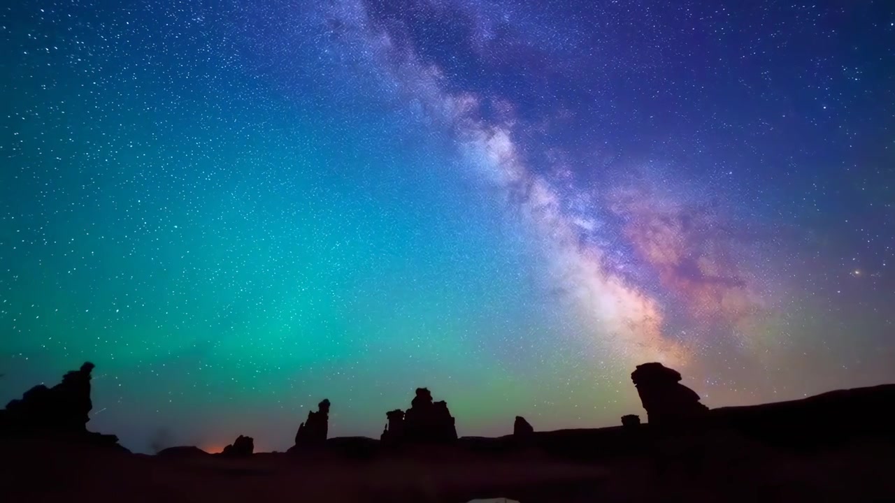 Time Lapse of Milky Way and Aurora Over Desert Landscape