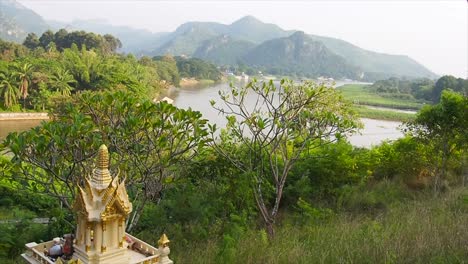 religious buddhist statue overseeing river kwai in thailand