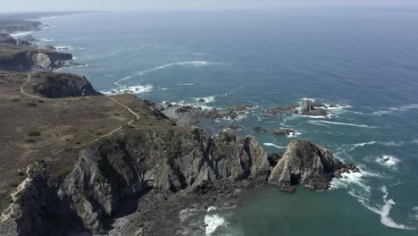 Amazing-cirkling-shot-of-cliffs-at-Zambujeira-do-Mar,-Portugal