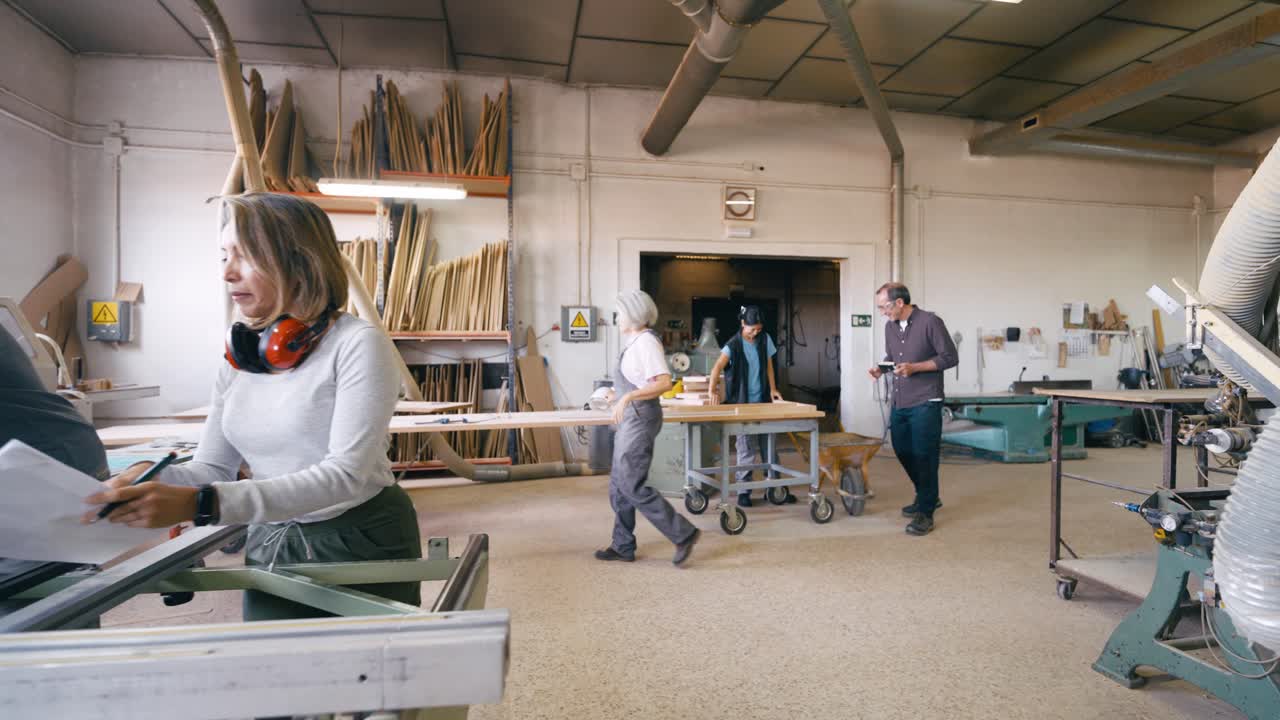 Diverse Team of Woodworkers Collaborating in a Busy Carpentry Workshop