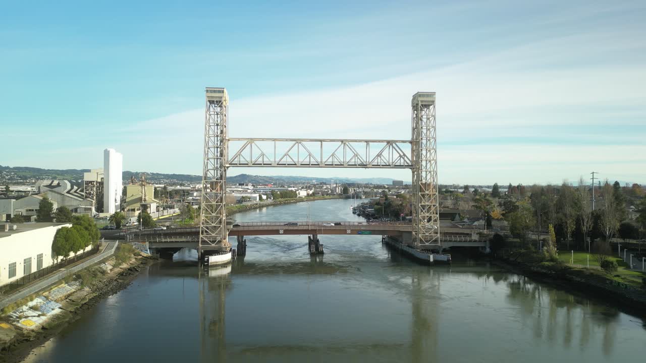 Sweeping drone views highlight the Miller Sweeney Bridge’s design as it spans the Oakland Estuary, linking Alameda and Oakland with a steady flow of vehicles crossing.