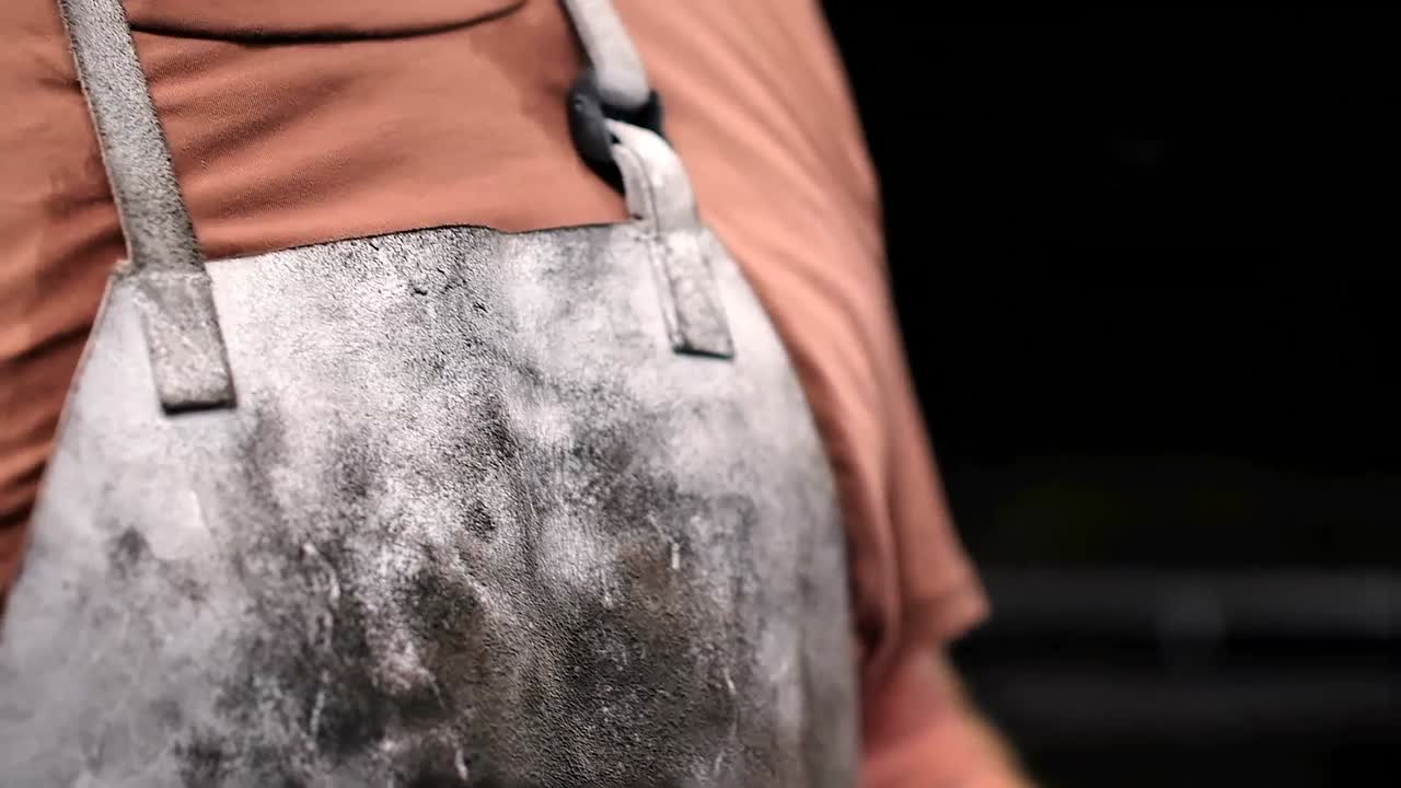 Blacksmith holding cigarette in workshop 4k