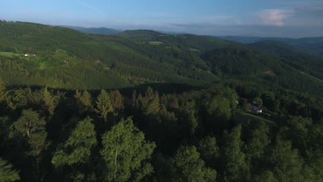 breathtaking mountains full of green trees with a blue sky in the background in summer