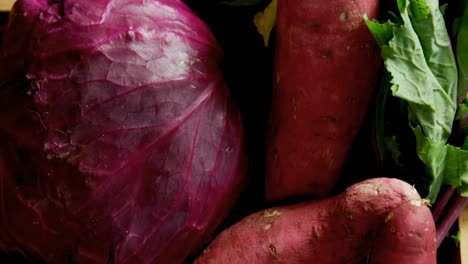 Various-vegetables-in-basket-on-wooden-surface-4K-4k