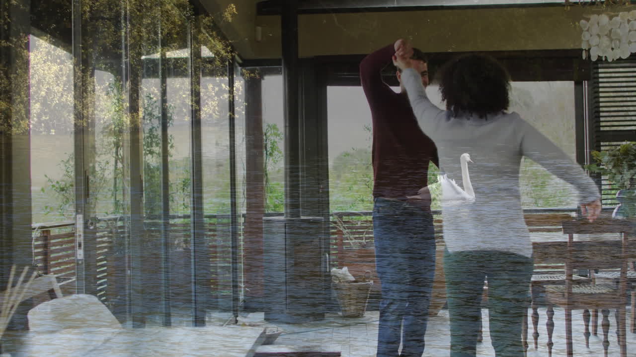 Couple dancing joyfully at home over serene water reflection animation