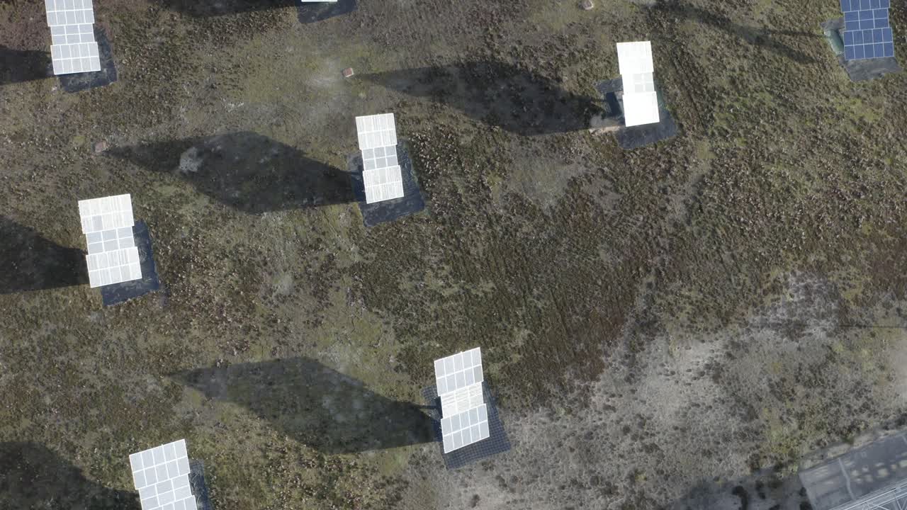 Top-down aerial view of multiple solar panels arranged in rows on ground, renewable energy generation, Castets, France