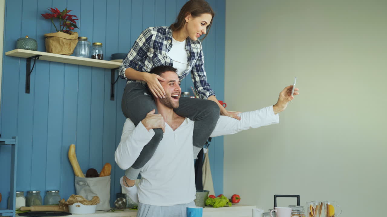 Una pareja divirtiéndose en la cocina.