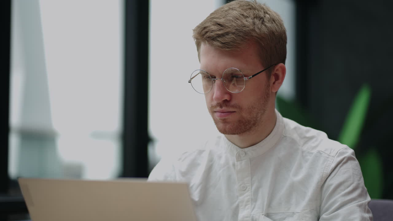 male programmer is working in office or in home portrait of man with laptop sending emails