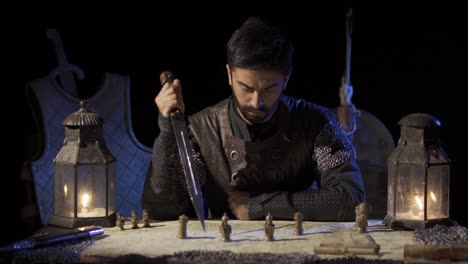 soldier marking the map with the sword in his hand.