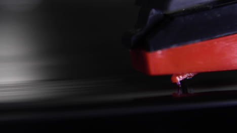 a macro shot of a record player needle being dropped onto a spinning record-vinyl