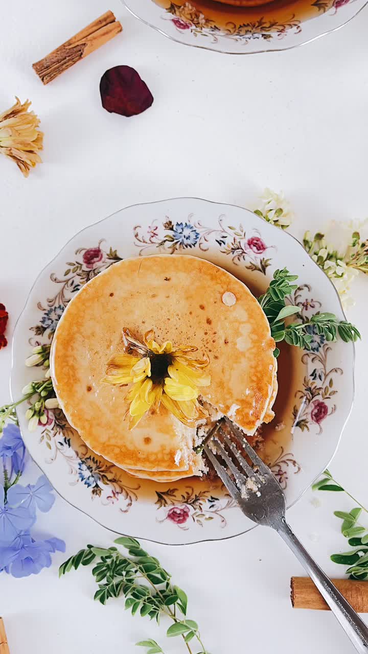 Delicious Stacked Pancakes with Flowers and Syrup