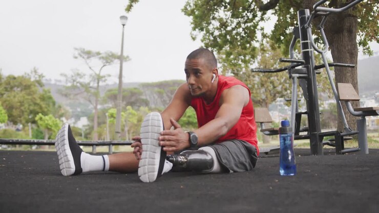 Side view man with prosthetic leg stretching