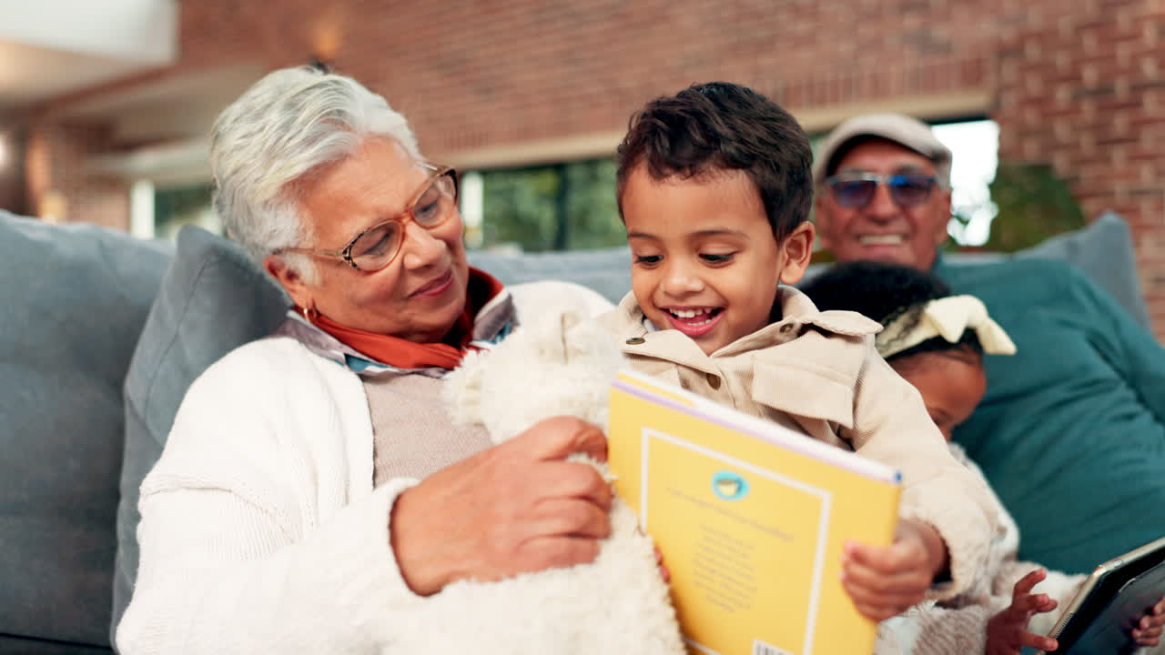 Happy Grandmother Reading a Book with Grandchildren on Sofa