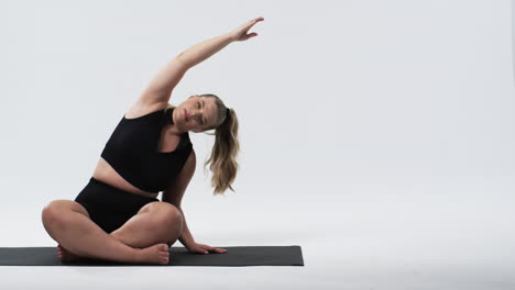 blonde beautiful plus size woman stretching yoga , promoting body positivity and fitness, copy space