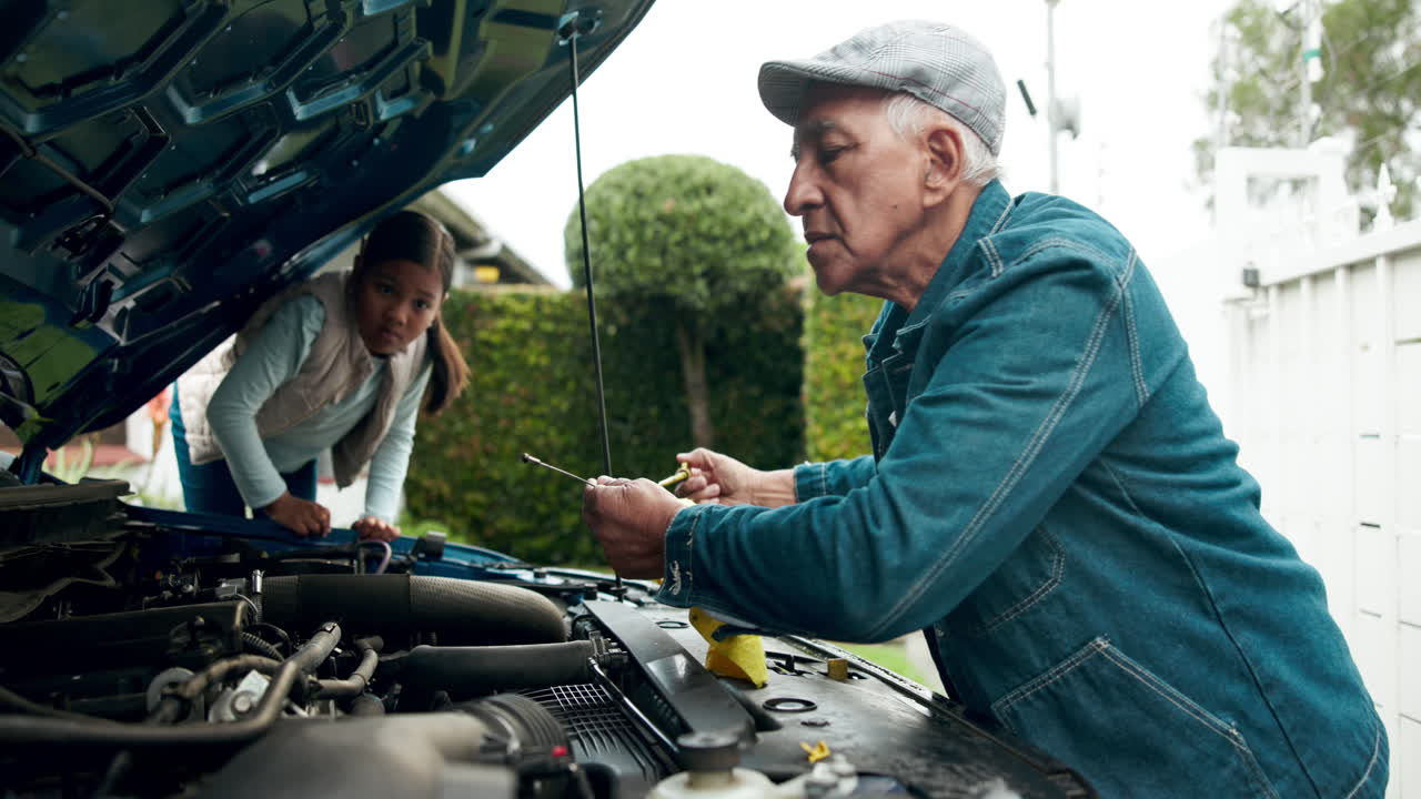 Grandfather and Granddaughter Repairing Car Engine