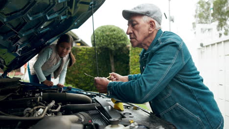 grandfather and granddaughter repairing car engine