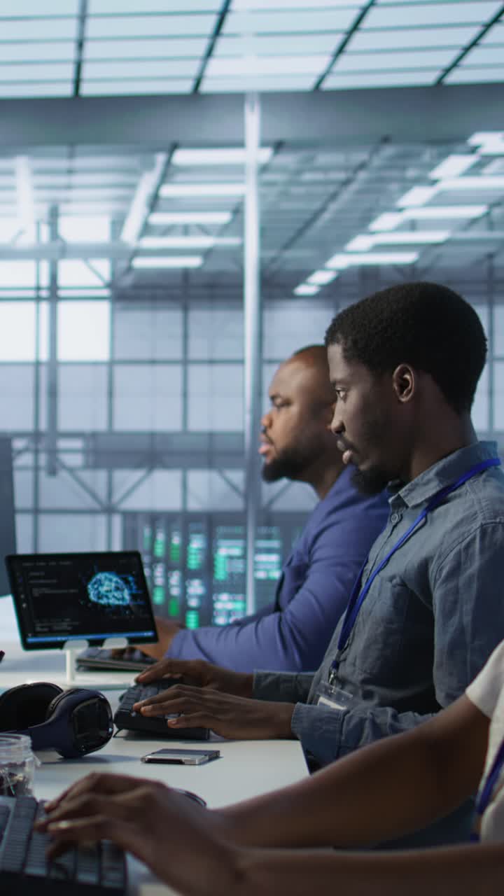 Vertical video Computer scientists in data center implementing AI systems