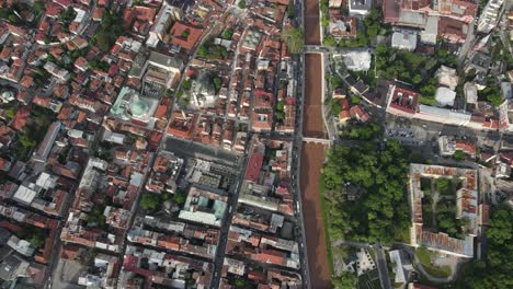 Drone-view-of-the-regular-planning-of-the-city-with-a-river-running-through-the-middle,-rich-city-of-Bosnia-where-cultural-heritages-coexist