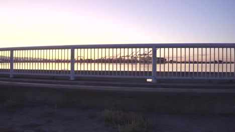 Giant-shipping-cranes-are-the-focus-as-a-railing-passes-to-the-right-to-a-cool-effect