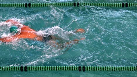 Fit-swimmer-doing-the-butterfly-stroke-in-the-swimming-pool