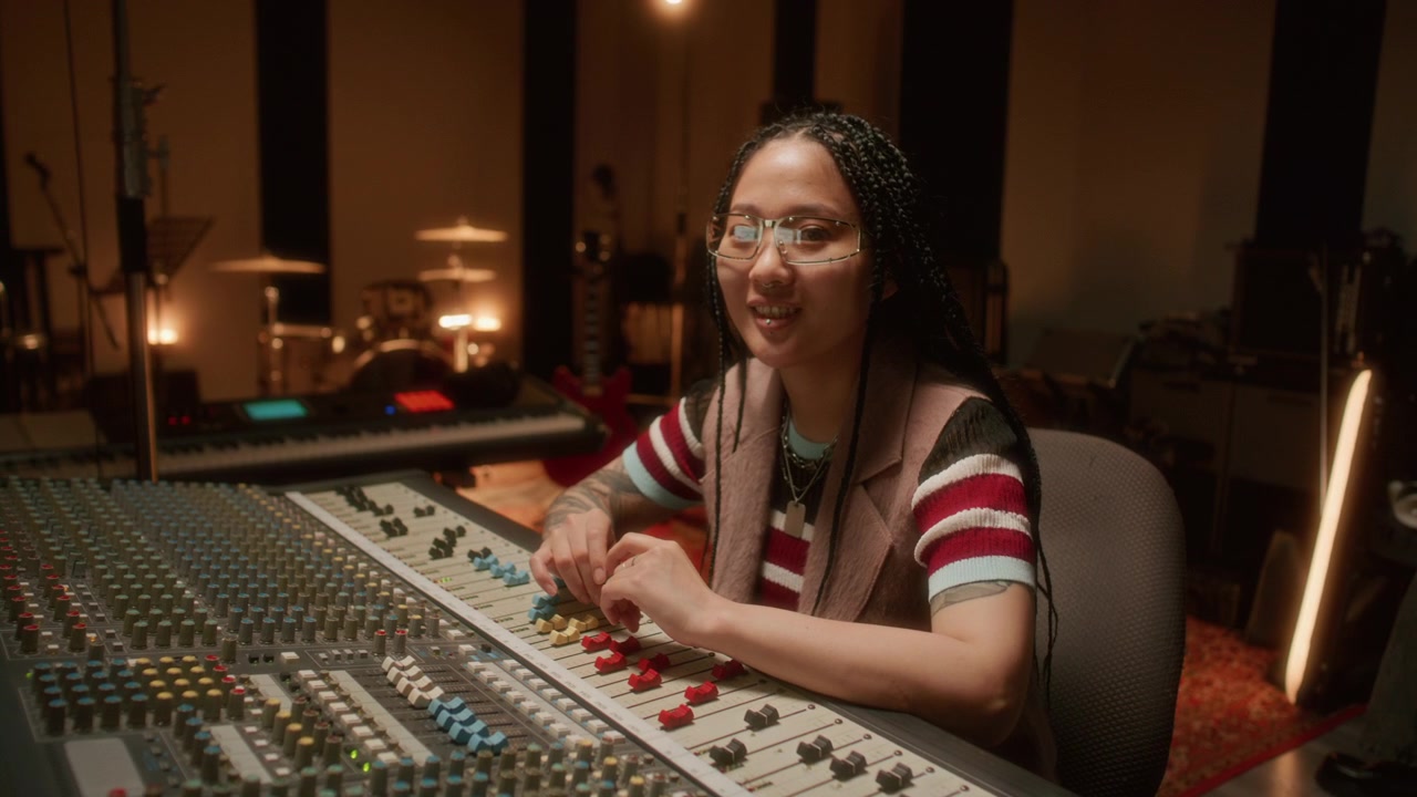Portrait of Asian Female Sound Producer Working in Music Recording Studio