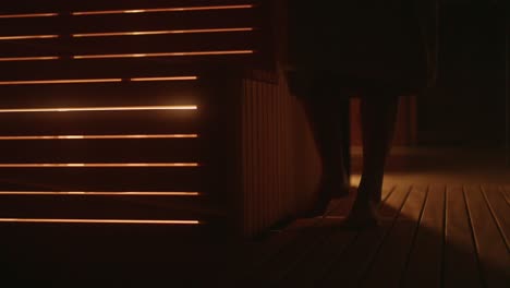 Closeup-of-Woman's-feet-entering-cozy-sauna-during-winter-in-wellness-hotel