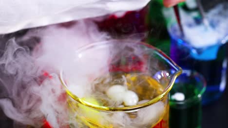 vibrant liquids and smoke in scientific experiment