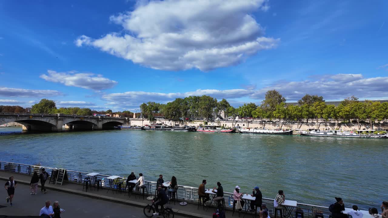 Seine river boat Paris capital of France with people walking summer day