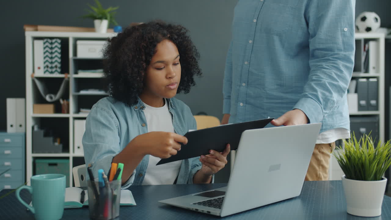 Young Woman Discussing a Document in the Office