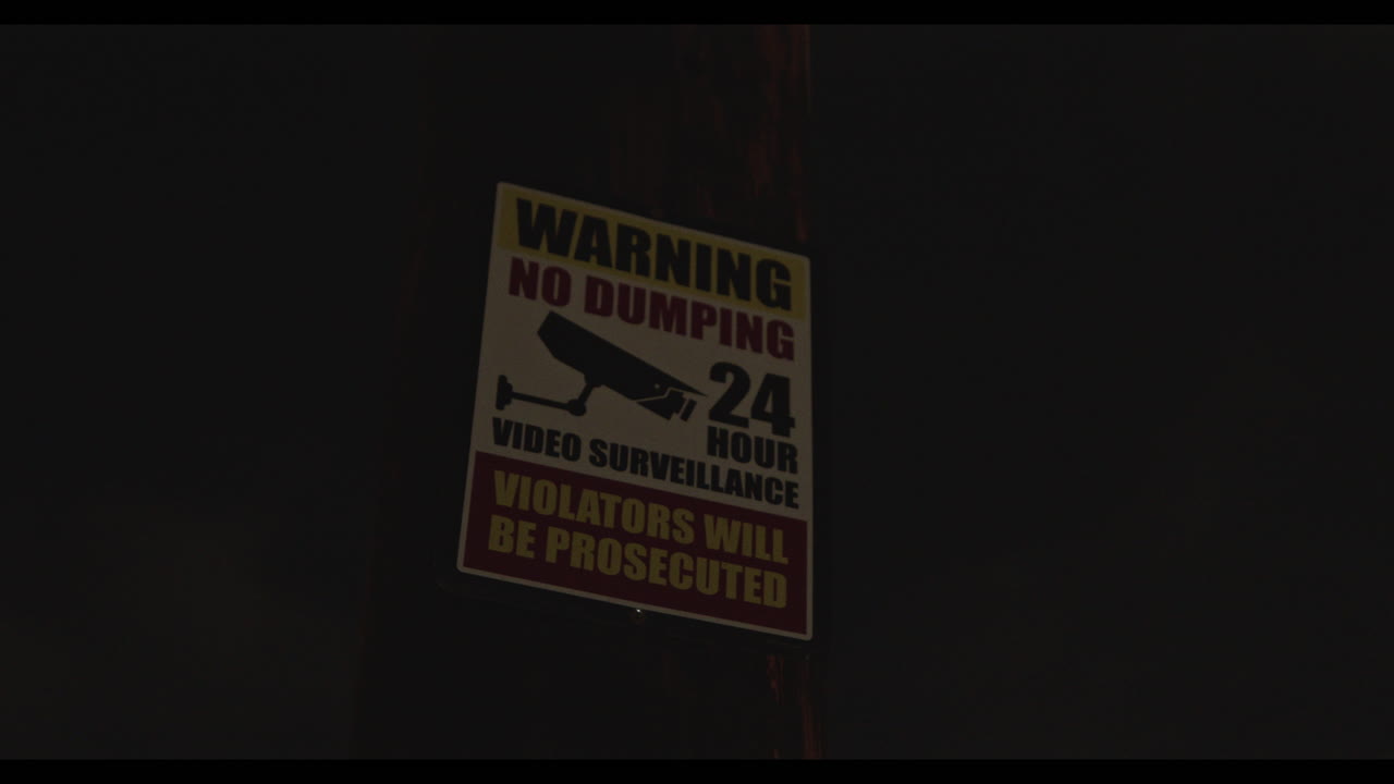 Video of the signboard advising people not to dump trash or else they will be prosecuted and that the area is under surveillance