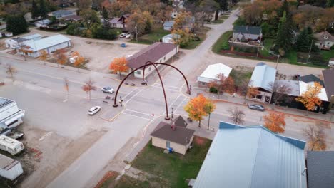A-Wide-Angle-Car-Driving-by-Drone-Shot-of-the-Northern-Canadian-Landscape-a-Small-Rural-Town-Skiing-Fishing-Village-Main-Street-Arches-in-Asessippi-Community-in-Binscarth-Russell-Manitoba-Canada