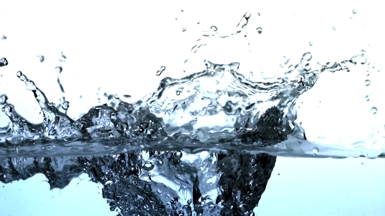 Clear water splashing in slow motion creating ripples and bubbles