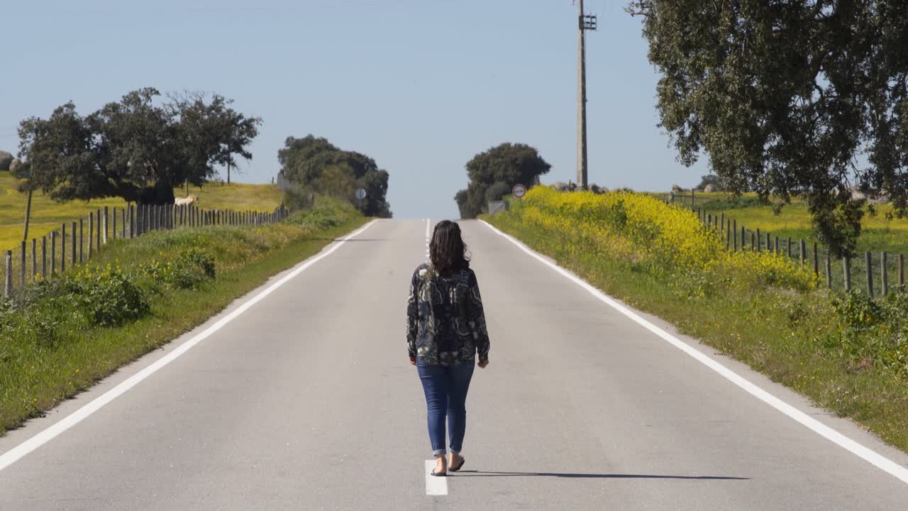 Woman on the middle of a road in Alentejo, Portugal