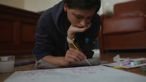 young woman painting at home