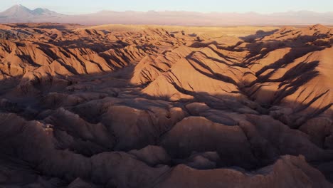 Undeveloped-badlands-wilderness-landscape,-golden-hour-aerial-view