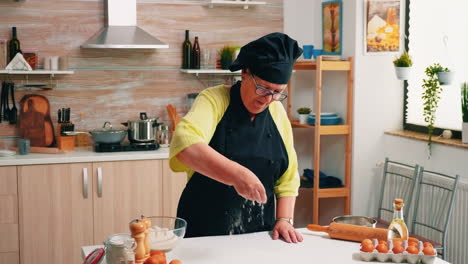 Adding-flour-on-table-by-hand