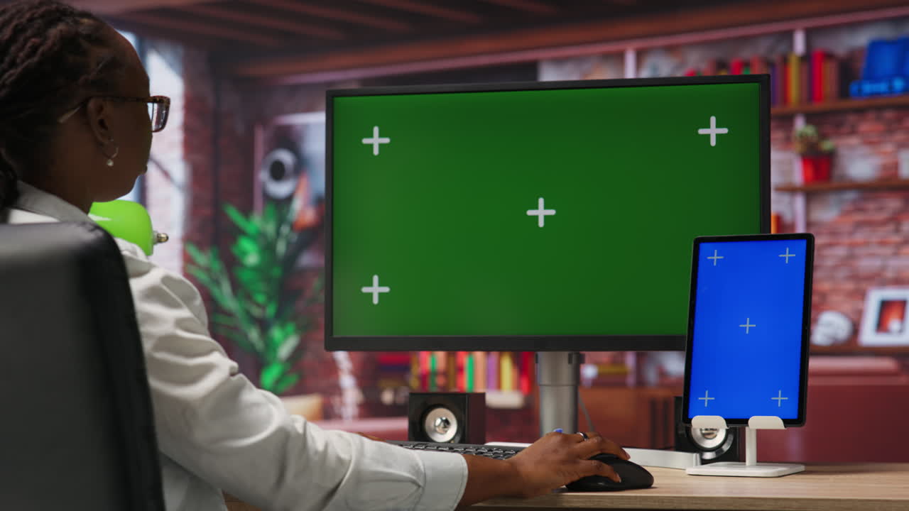 Remote employee in home office using green screen PC and mockup tablet
