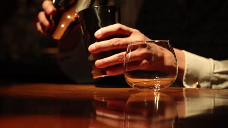 sequence of a bartender shaking and serving a drink