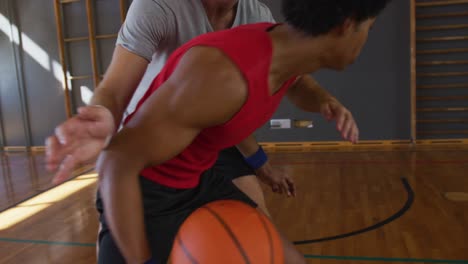 African-american-male-basketball-player-and-his-teammate-practice-dribbling-ball