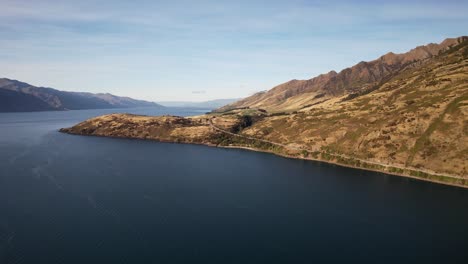 aerial view of lake hawea and mountains on a sunny summer day in west coast, south island, new zealand.