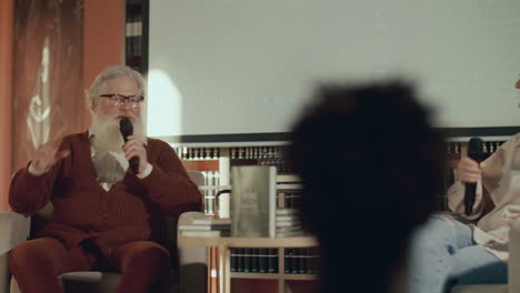 female journalist interviewing senior author at book launch event